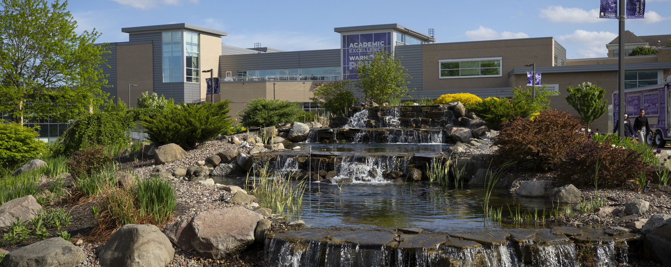 The University Center with a purple banner that says Academic Excellence and Warhawk Pride.