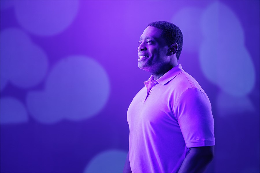 A person with their hands on their hips looks into the distance.