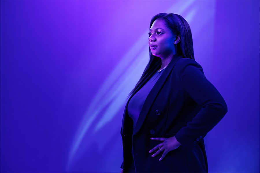 A person with their hands on their hips looks into the distance.