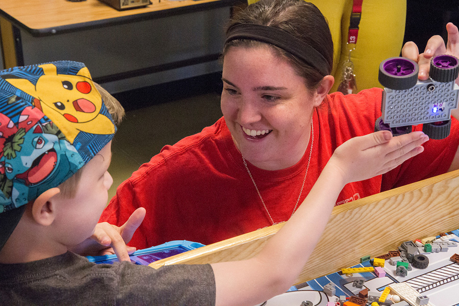 A student works with a child.